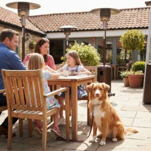 A family dining on a sunny, heated outdoor patio with a friendly dog sitting next to their table.